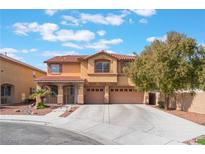 Inviting two-story home boasts a red tile roof, desert landscaping, and a spacious three-car garage at 4133 Perfect Lure St, Las Vegas, NV 89129