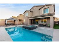 Stunning backyard pool and spa with a covered outdoor dining area, perfect for entertaining guests at 4220 Porticella Ave, North Las Vegas, NV 89084