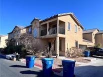 Two-story home featuring stucco siding, a small balcony, desert landscaping, and a tile roof at 4626 Lime Straight Dr, Las Vegas, NV 89115