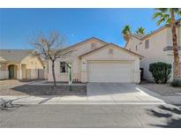 Single-story house with a two-car garage and desert landscaping at 5205 Mantua Ct, Las Vegas, NV 89130