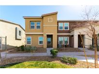 Two-story home with beige and brown facade, landscaped front yard, sidewalk and visible house numbers at 546 Foothill Cove Ln, Henderson, NV 89002