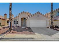 Single-story house with a two-car garage and desert landscaping at 6425 Mountain Mesa Ave, Las Vegas, NV 89156