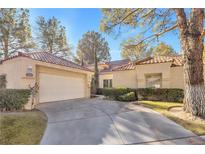 Charming single-story home with a well-manicured lawn and a two-car garage at 6961 Emerald Springs Ln, Las Vegas, NV 89113