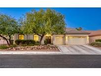 Charming single story home with a two car garage, desert landscaping, and mature trees at 10528 Meadow Mist Ave, Las Vegas, NV 89135