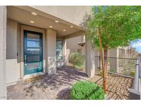 Modern teal front door with covered entryway and landscaped courtyard at 11713 Redwood Mountain Ave, Las Vegas, NV 89138