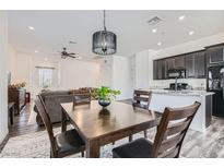 Open dining area featuring a wood table with chairs and a modern chandelier at 216 Copland Canyon Ave, Henderson, NV 89011