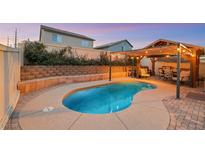 Inviting pool with a covered patio and stylish lighting, perfect for relaxing outdoors at 2737 Sunrise Day Ct, Las Vegas, NV 89142