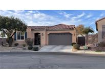 Charming single-story home featuring a well-manicured lawn and a two-car garage at 2764 Leys Burnett Ave, Henderson, NV 89044