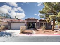 Charming single-story home featuring a tile roof, desert landscaping, and a two-car garage at 2987 Matese Dr, Henderson, NV 89052