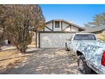 House exterior featuring a single-car garage and a driveway at 3883 Steinbeck Dr, Las Vegas, NV 89115