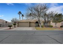 Charming single-story home featuring a well-manicured lawn, mature trees, and a spacious three-car garage at 6105 Port Of Dreams Dr, Las Vegas, NV 89130