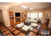 Spacious living room featuring a fireplace and built-in shelving at 9408 Forest Edge Ave, Las Vegas, NV 89149