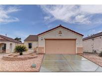 Charming single-story home featuring a terra cotta tile roof, desert landscaping, and an attached two-car garage at 1073 Silver Bullet Ct, Henderson, NV 89011