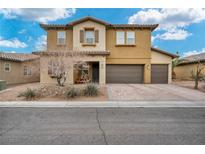 Charming two-story home with a three-car garage and beautiful desert landscaping at 2593 Indigo Cloud Ct, Las Vegas, NV 89142