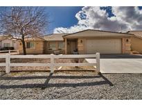 Inviting single-story home with a well-maintained front yard and an attached two-car garage at 3714 Mount Charleston Dr, Pahrump, NV 89048