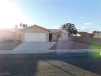 One-story house with a white garage door and desert landscaping at 4225 Seth Dr, North Las Vegas, NV 89032