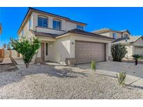 Charming two-story home featuring a two-car garage and low-maintenance desert landscaping at 6027 Stone Hollow Ave, Las Vegas, NV 89156