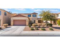 Two-story house with a two-car garage and nicely landscaped front yard at 6713 Chambers Lake Ct, North Las Vegas, NV 89084