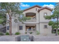 Exterior view of the building featuring balconies and desert landscaping in front at 8250 N Grand Canyon Dr # 1040, Las Vegas, NV 89166