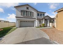 Charming two-story home with a two-car garage, manicured lawn, and a welcoming entrance at 8389 Charlton Valley Ct, Las Vegas, NV 89123