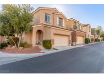 Charming townhome featuring a two-car garage, desert landscaping, and inviting front entrance at 10221 Mayflower Bay Ave, Las Vegas, NV 89166