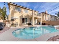 Inviting backyard oasis with sparkling pool, patio area, and string lights, perfect for outdoor entertaining at 11009 Pentland Downs St, Las Vegas, NV 89141