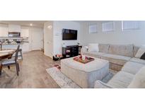 Bright, open-concept living room with modern furnishings and a large sectional couch at 1132 Ruby Sparrow St, Henderson, NV 89011