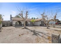 Charming single-story home with desert landscaping and mature trees in a residential neighborhood at 1841 Golden Shadow Dr, Henderson, NV 89002