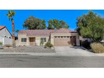Charming single-story home featuring a tiled roof, desert landscaping, and an attached two-car garage at 2414 Inlet Beach Ct, North Las Vegas, NV 89031