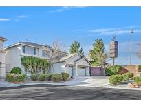 Two-story home with a two-car garage, manicured landscaping, and concrete driveway on a sunny day at 3017 Lenoir St, Las Vegas, NV 89135