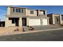 Two-story home with a two-car garage and a modern stone facade at 7142 Twilight Rider Ct, Las Vegas, NV 89118