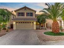 Charming two-story home featuring a well-manicured front yard and a spacious two-car garage at 10899 Royal Highlands St, Las Vegas, NV 89141