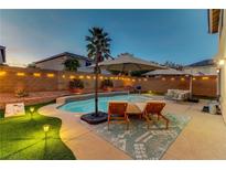 Inviting backyard pool with lounge chairs, string lights, and well-maintained landscaping, perfect for outdoor relaxation at 10899 Royal Highlands St, Las Vegas, NV 89141