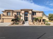 Elegant two-story home featuring a grand entrance, well-manicured landscaping and a spacious three car garage at 1534 Waterford Falls Ave, Las Vegas, NV 89123