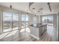 Bright, open kitchen with stainless steel appliances, a kitchen island, and stunning city views from the large windows at 200 W Sahara Ave # 2108, Las Vegas, NV 89102