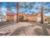 Charming single-story home with desert landscaping, mature trees, and a red tile roof at 2612 Springridge Dr, Las Vegas, NV 89134