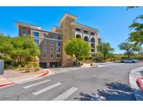 Attractive multi-story condo building with manicured landscaping and convenient garage access at 29 Montelago Blvd # 205, Henderson, NV 89011