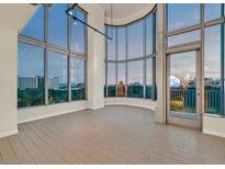 Bright living room with expansive windows offering city views and wood look tile flooring at 360 E Desert Inn Rd # 602, Las Vegas, NV 89109