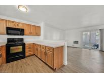 Bright kitchen features wooden cabinets, black appliances, and an open concept layout at 5394 Swenson St # 29, Las Vegas, NV 89119