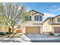 Charming two-story home featuring a paved driveway, two-car garage, and desert landscaping at 6489 Little Harbor Ct, Las Vegas, NV 89141