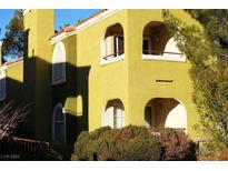 The two-story house features arched windows, stucco siding and a red tile roof with desert landscaping at 7950 W Flamingo Rd # 1139, Las Vegas, NV 89147