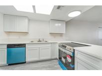 Bright kitchen features white cabinetry, new appliances, and modern countertops at 228 N Bruce St # D, Las Vegas, NV 89101