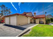 Charming exterior view featuring a well-manicured lawn and two-car garage at 2367 Pickwick Dr, Henderson, NV 89014