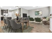 Inviting living and dining room with sleek furniture, wood floors, and a calming color palette at 6462 Silver Estates St, North Las Vegas, NV 89081