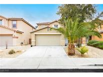 Inviting two-story home with a well-maintained yard and attached two-car garage at 6609 Pine Siskin Pl, North Las Vegas, NV 89084