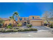 Inviting two-story home featuring a well-manicured yard, desert landscaping, and a spacious three-car garage at 7195 Morningside Ranch Ct, Las Vegas, NV 89113