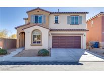 Two-story home with a two-car garage, arched entryway, and desert landscaping at 7203 Pepperbox Ave, Las Vegas, NV 89179