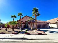 Charming single-Gathering home with a desert landscape, palm trees and a tile roof at 1269 Honey Lake St, Las Vegas, NV 89110