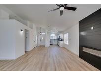Bright living room boasts wood floors, a modern fireplace, and an open floor plan to the kitchen at 1708 Matador Way, Las Vegas, NV 89128