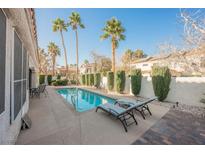 Inviting backyard pool area with lounge chairs and lush landscaping, perfect for relaxation and entertaining at 299 Francisco St, Henderson, NV 89014
